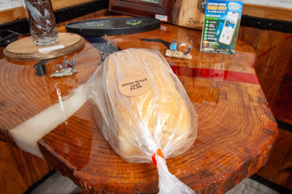A fresh-baked loaf of white bread in a bag
